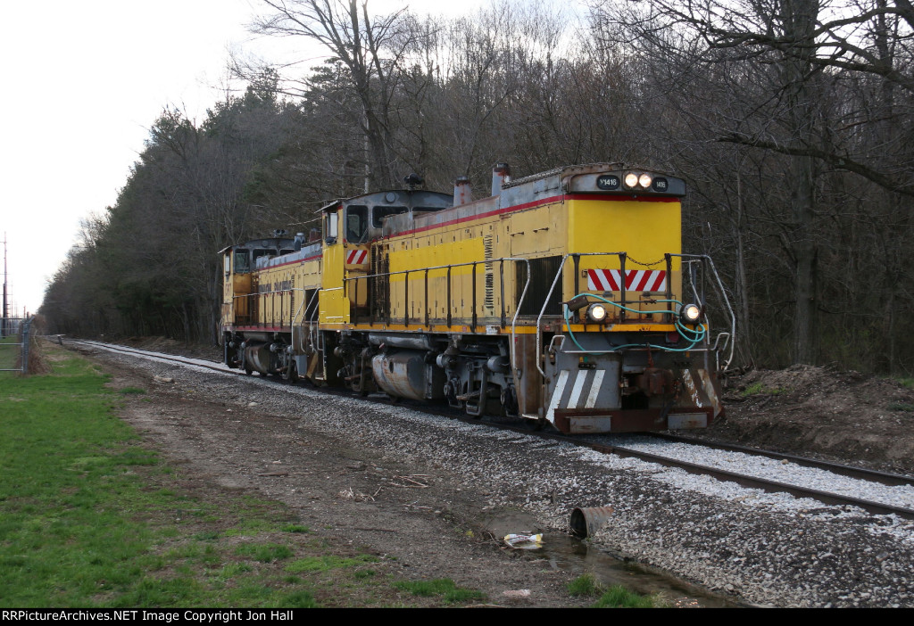 With time and money invested by the new owners, the track of"the West Michigan Railroad is starting to look better as 1416 heads for the transload